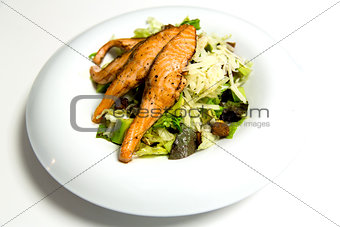 Grilled salmon steak with herbs and vegetables