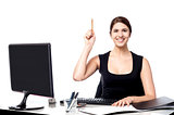 Businesswoman holding pen and raising her hand