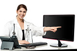 Female physician pointing at computer screen
