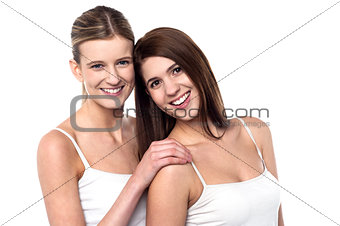 Two attractive girls posing in sleeveless spaghetti