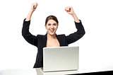 Excited businesswoman raising her arms up
