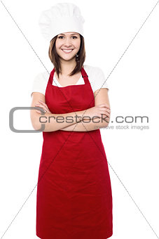 Young female chef with folded arms