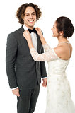 Bride adjusting her man's bow tie