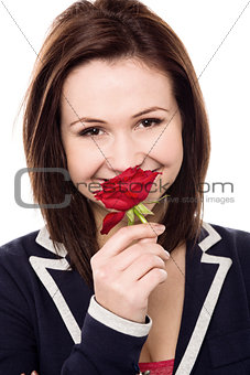 Lovely young girl with a beautiful red rose