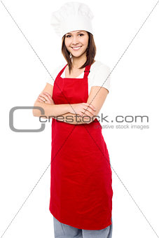 Young baker woman with folded arms