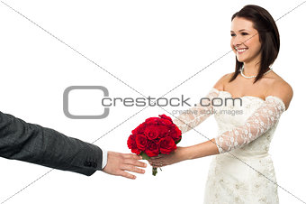 Bride offering her token of love to the groom