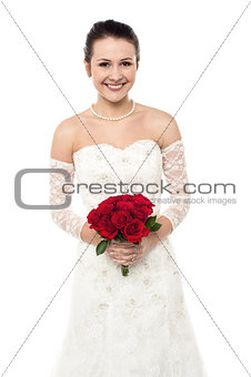 Cheerful young girl in bright bridal dress