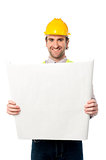 Male construction worker holding blueprint