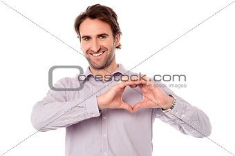 Man making heart symbol with hands