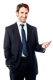 Smiling corporate head holding out cellphone