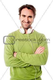 Smart male with headphones around his neck