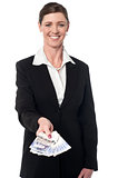 Smiling corporate woman showing british pound