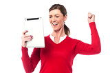 Excited pretty woman holding touch pad