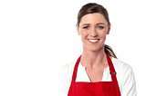 Attractive female chef wearing red apron