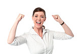 Excited corporate lady with clenched fists