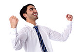Excited businessman celebrates by pumping fists
