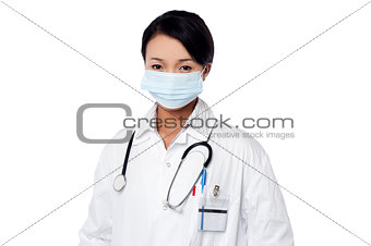 Young female surgeon wearing face mask