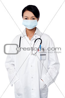 Female surgeon posing with hands in lab coat