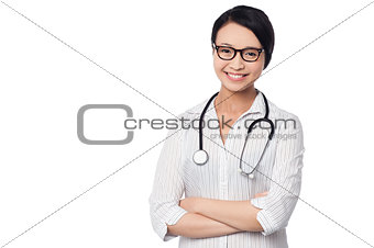 Young pretty female doctor with arms folded