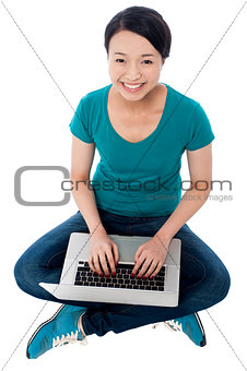 Cheerful attractive girl working on laptop