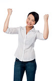 Excited charming girl with clenched fists