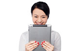 Shy pretty corporate lady holding tablet device