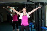 Lady holding dumbbells in her outstretched arms