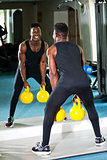 Young muscular man working out with kettlebell