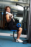 Man exercising with help of a hydraulic equipment