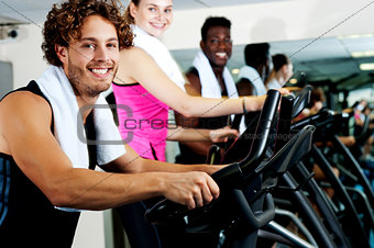 People at  gym working out happily