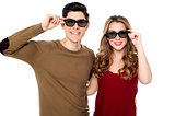 Young couple posing to camera with shades on