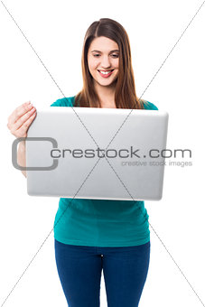 Cute young girl watching videos on laptop