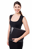 Pretty female secretary holding business files