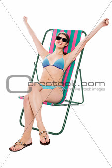 Young bikini woman relaxing on deckchair