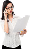 Female analyzing annual business reports