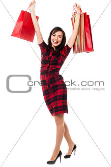 Excited shopping girl having great fun