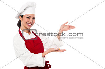 Female chef presenting something