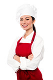 Cheerful confident young female chef