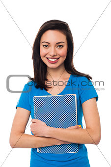 Young girl holding notebook