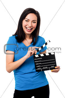 Young girl holding clapperboard