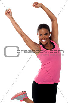 Pretty girl in sportswear jumping with joy
