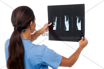 Female doctor looking at patient's x-ray report