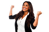 Excited businesswoman with clenched fists