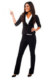 Young businesswoman pointing away