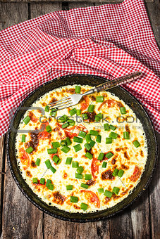 Scrambled eggs with green onions in a large skillet