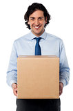 Male executive holding cardboard box