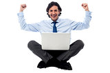 Excited young professional with laptop