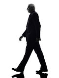senior business man walking silhouette