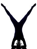 woman exercising vrschikasana scorpion pose yoga silhouette