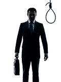 business man in front of  hangman noose silhouette